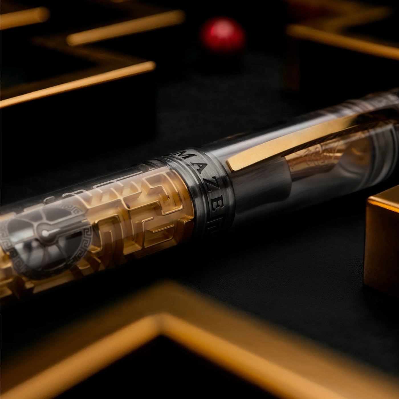 Close-up of ruby sphere inside the golden maze of Visconti Maze pen.