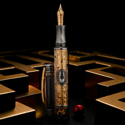Visconti Maze pen uncapped, revealing 18k gold nib and intricate section trim.