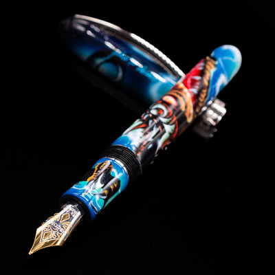 Visconti Mazzi Dragon Limited Edition Fountain Pen laying across its own cap, crossed, with a focus on the nib.