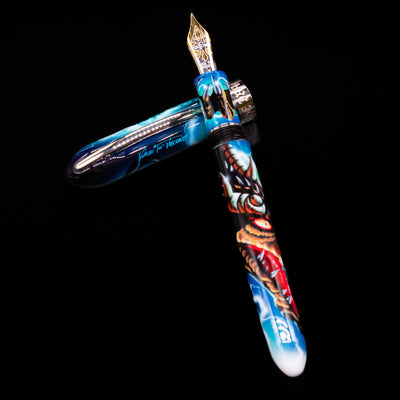 Visconti Mazzi Dragon Limited Edition Fountain Pen laying on top of its cap in a crossed position showing full view of the entire uncapped pen.