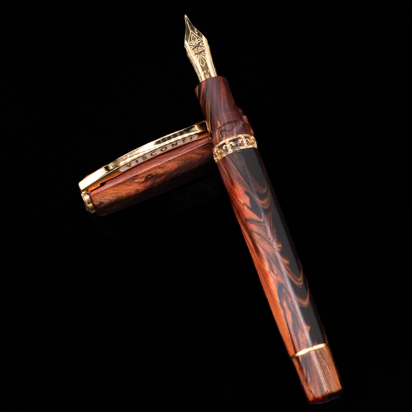Visconti Medici Briarwood Fountain Pen in Gold leaning on its cap, crossed, showcasing the full view of the pen.