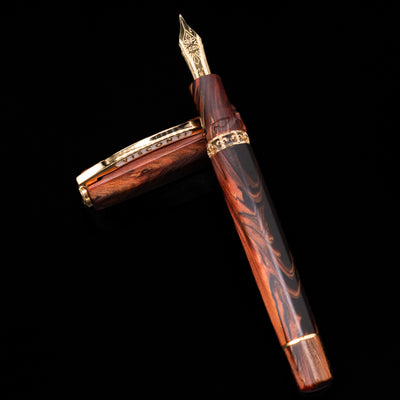 Visconti Medici Briarwood Fountain Pen in Gold leaning on its cap, crossed, showcasing the full view of the pen.