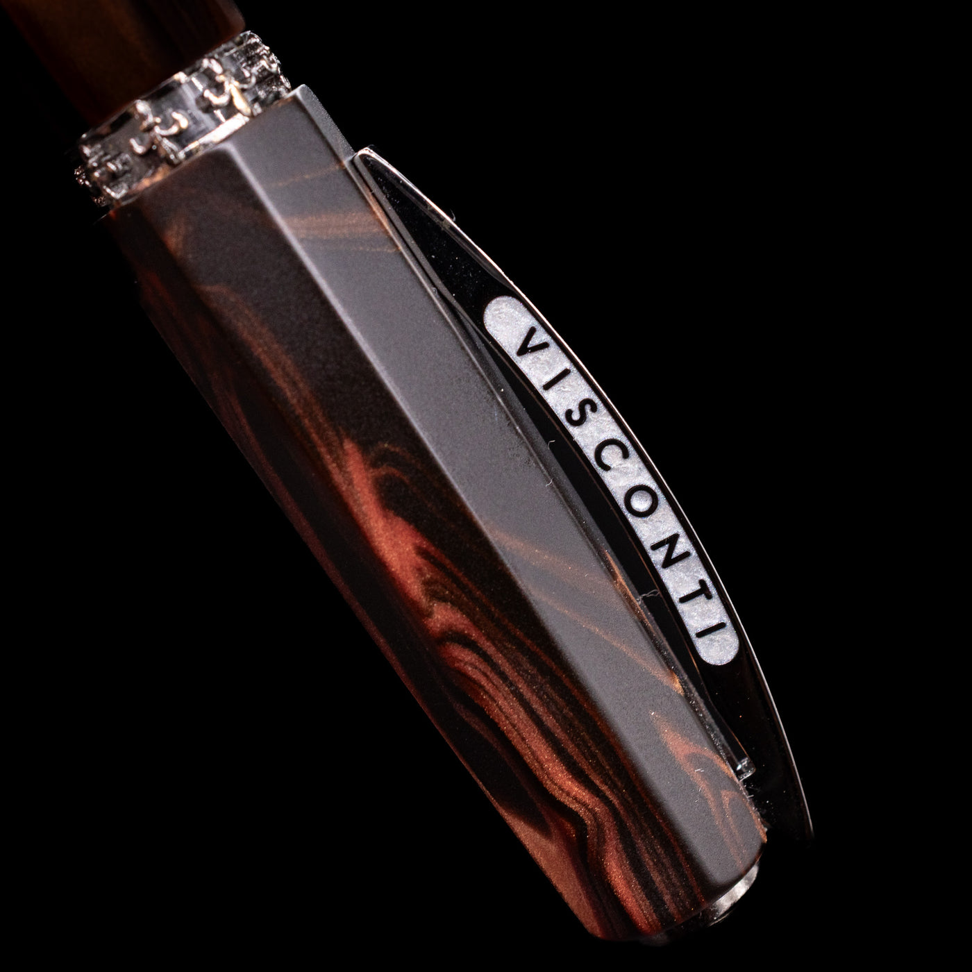 Close-up view of the cap and its bridge-like clip with the Visconti logo on the Visconti Medici Briarwood Fountain Pen in Ruthenium.