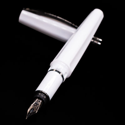 Visconti Mirage Athena Fountain Pen - Preowned laying across its own cap, crossed, with a focus on the nib.