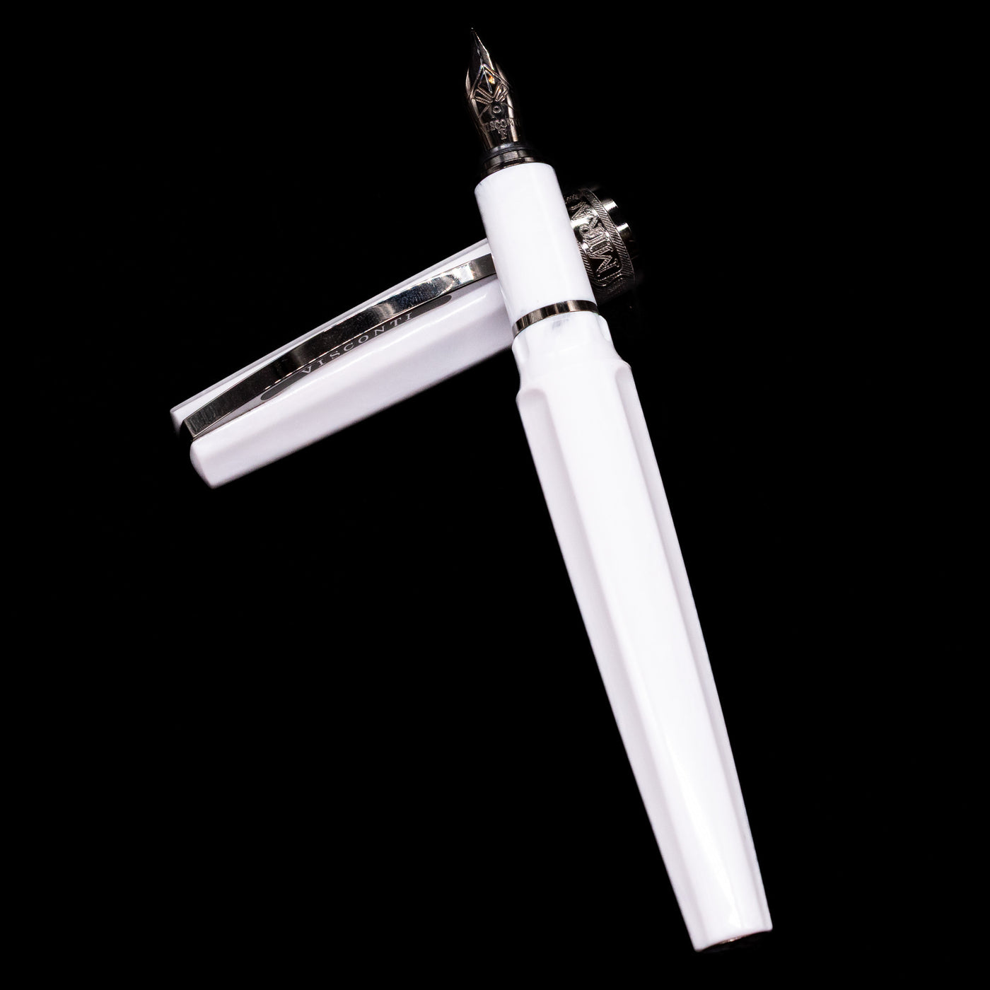  Visconti Mirage Athena Fountain Pen - Preowned laying on top of its cap in a crossed position showing full view of the entire uncapped pen.
