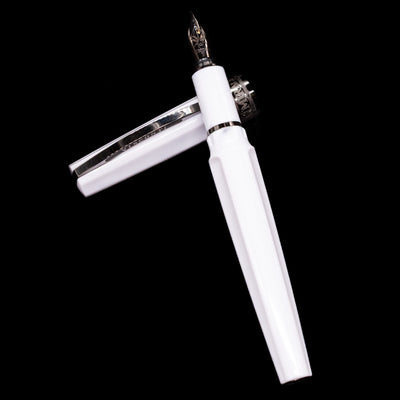  Visconti Mirage Athena Fountain Pen - Preowned laying on top of its cap in a crossed position showing full view of the entire uncapped pen.