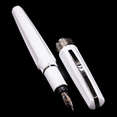 A full view of the Visconti Mirage Athena Fountain Pen - Preowned uncapped, with its cap laying next to the pen. 