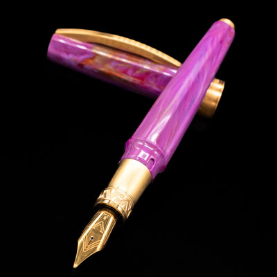 Visconti Mirage Mythos Fountain Pen - Aphrodite laying across its own cap, crossed, with a focus on the nib.