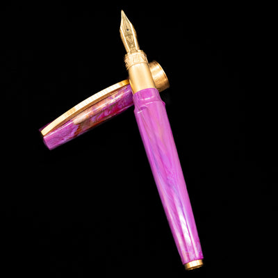 Visconti Mirage Mythos Fountain Pen - Aphrodite laying on top of its cap in a crossed position showing full view of the entire uncapped pen.