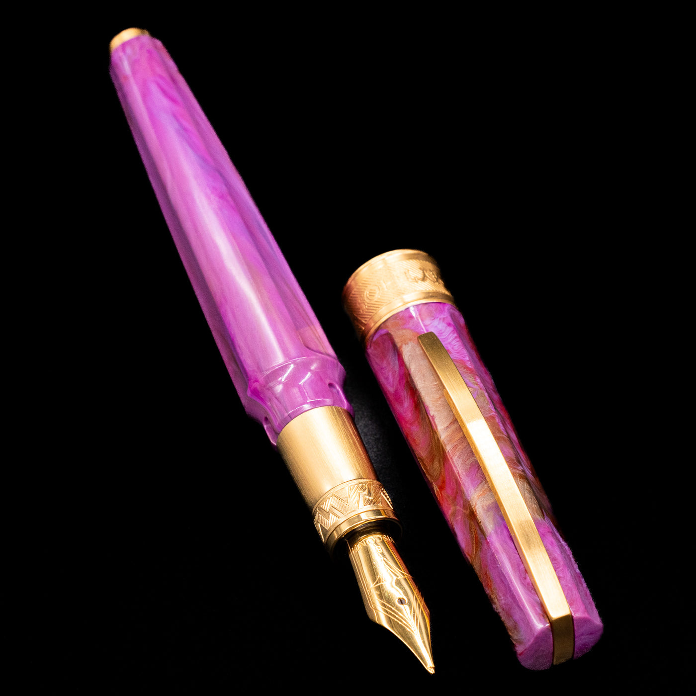 A full view of the Visconti Mirage Mythos Fountain Pen - Aphrodite uncapped, with its cap laying next to the pen.