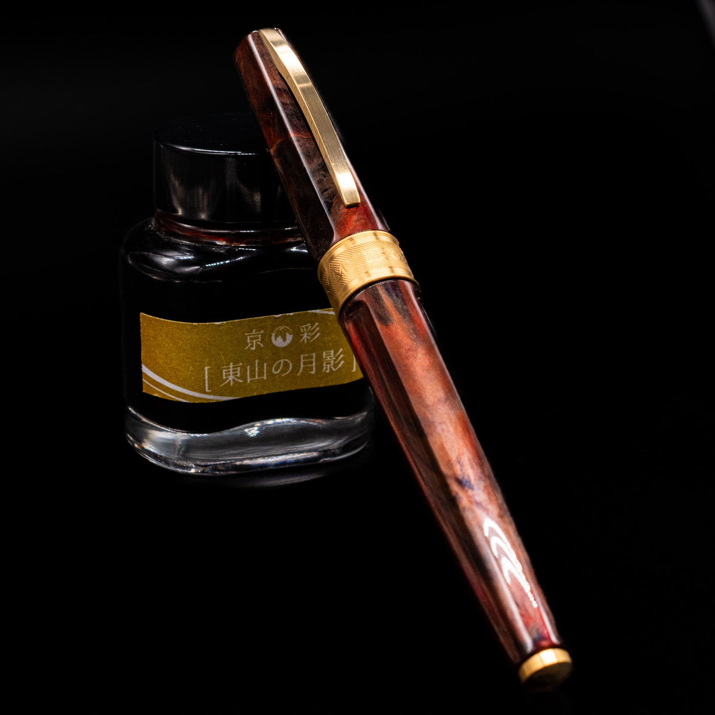 Visconti Mirage Mythos Fountain Pen - Apollo capped, leaning against an ink bottle. 
