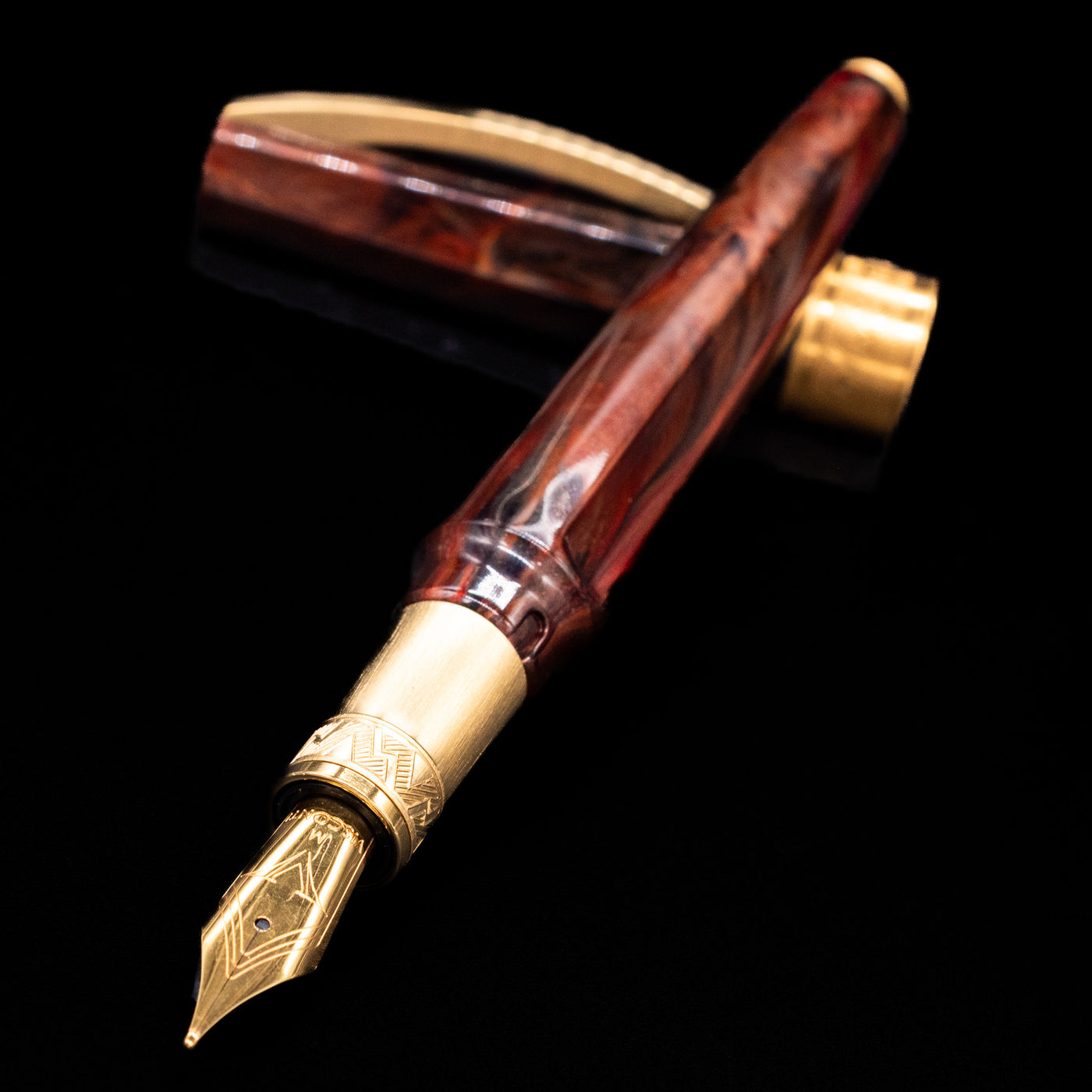 Visconti Mirage Mythos Fountain Pen - Apollo laying across its own cap, crossed, with a focus on the nib.