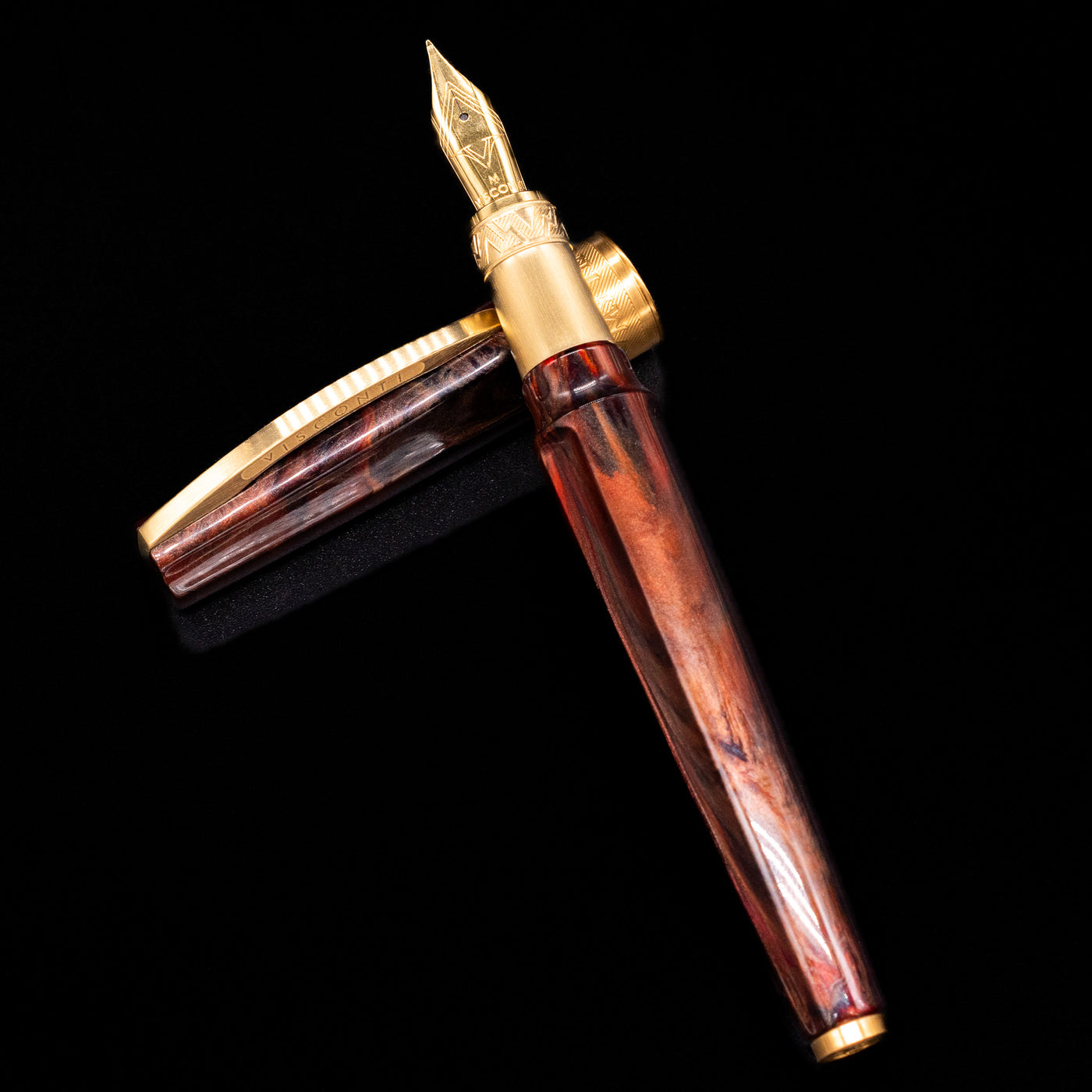 Visconti Mirage Mythos Fountain Pen - Apollo laying on top of its cap in a crossed position showing full view of the entire uncapped pen.