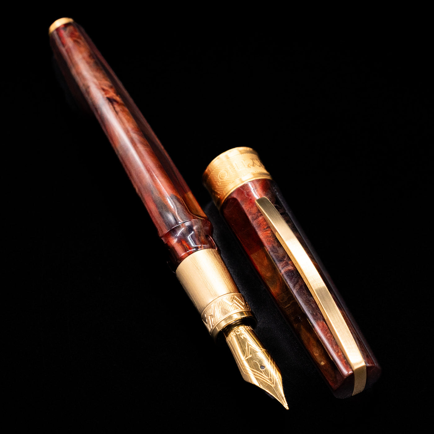 A full view of the Visconti Mirage Mythos Fountain Pen - Apollo uncapped, with its cap laying next to the pen.