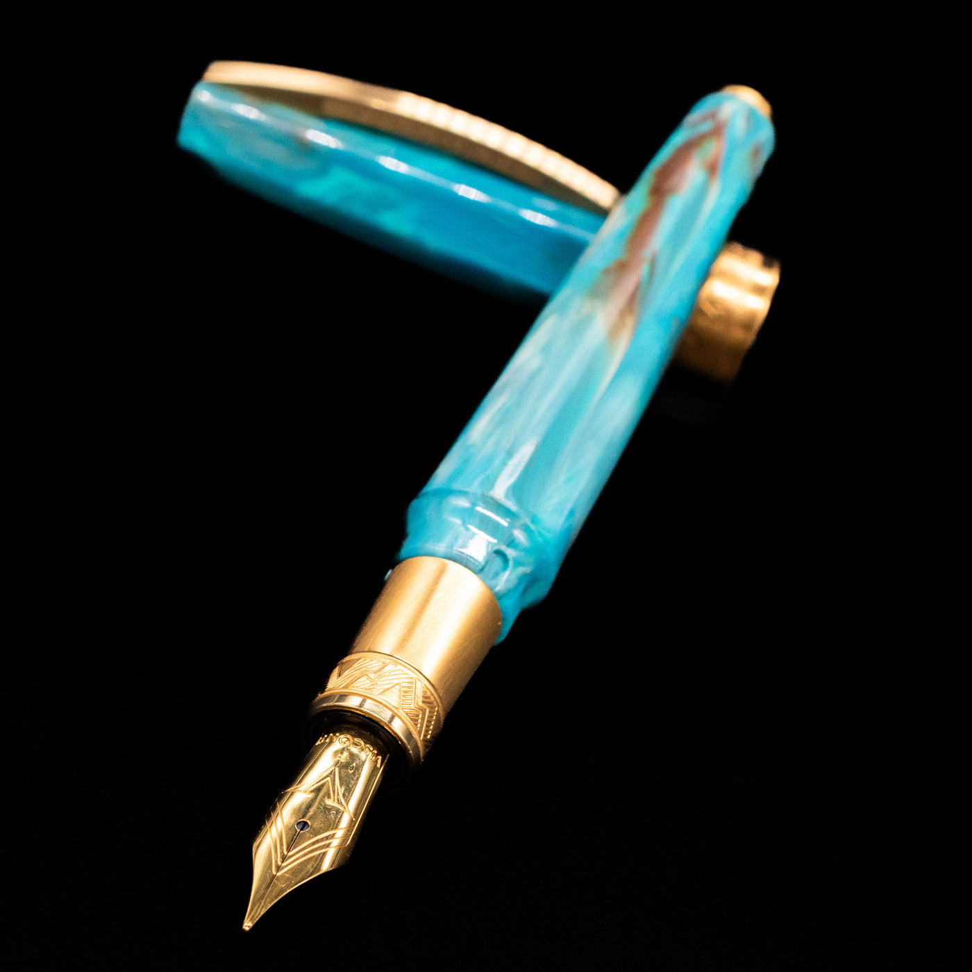 Visconti Mirage Mythos Fountain Pen - Athena laying across its own cap, crossed, with a focus on the nib.