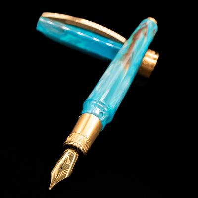 Visconti Mirage Mythos Fountain Pen - Athena laying across its own cap, crossed, with a focus on the nib.