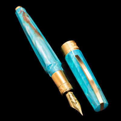 A full view of the Visconti Mirage Mythos Fountain Pen - Athena uncapped, with its cap laying next to the pen.
