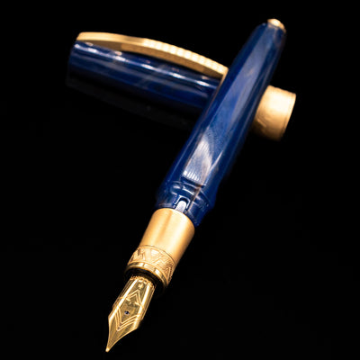Visconti Mirage Mythos Fountain Pen - Zeus laying across its own cap, crossed, with a focus on the nib.