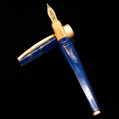 Visconti Mirage Mythos Fountain Pen - Zeus laying on top of its cap in a crossed position showing full view of the entire uncapped pen.