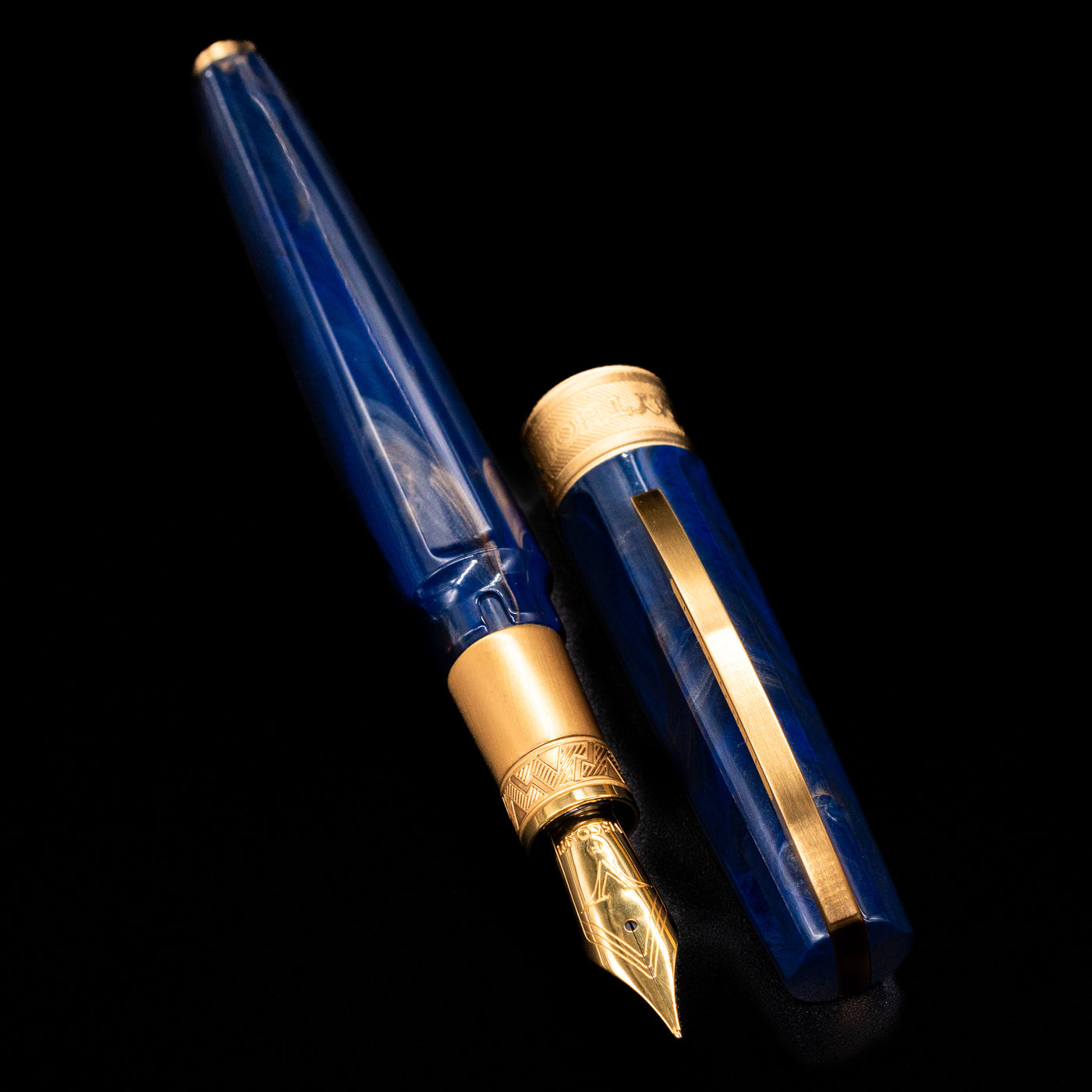 A full view of the Visconti Mirage Mythos Fountain Pen - Zeus uncapped, with its cap laying next to the pen. 