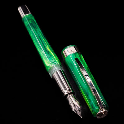  A full view of the Visconti Opera Carousel Fountain Pen - Green Mint uncapped, with its cap laying next to the pen. 