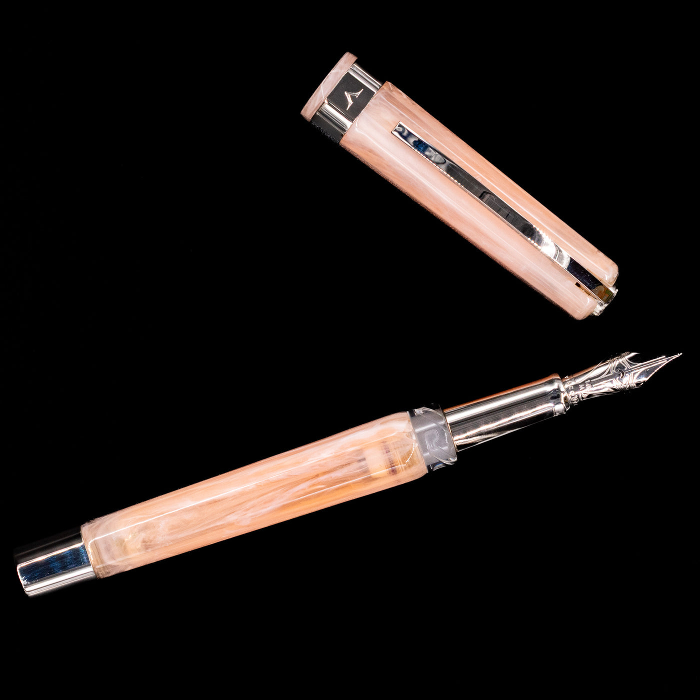 An overhead view of the Visconti Opera Carousel Fountain Pen - Pink Blush uncapped.