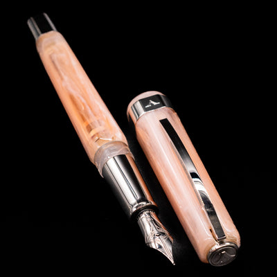 A full view of the Visconti Opera Carousel Fountain Pen - Pink Blush uncapped, with its cap laying next to the pen. 