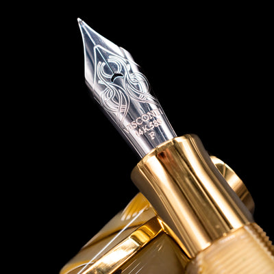 A macro shot of the nib with its intricate detailing and logo engraving for the Visconti Opera Club Honey Almond Resin Fountain Pen - Preowned.