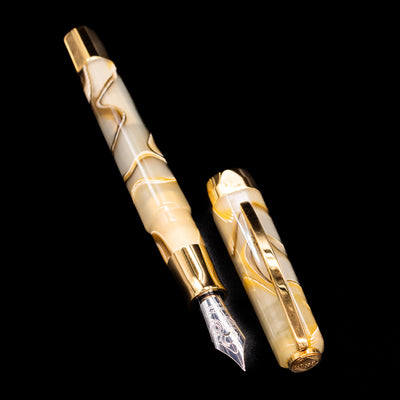 A full view of the Visconti Opera Club Honey Almond Resin Fountain Pen - Preowned uncapped, with its cap laying next to the pen. 