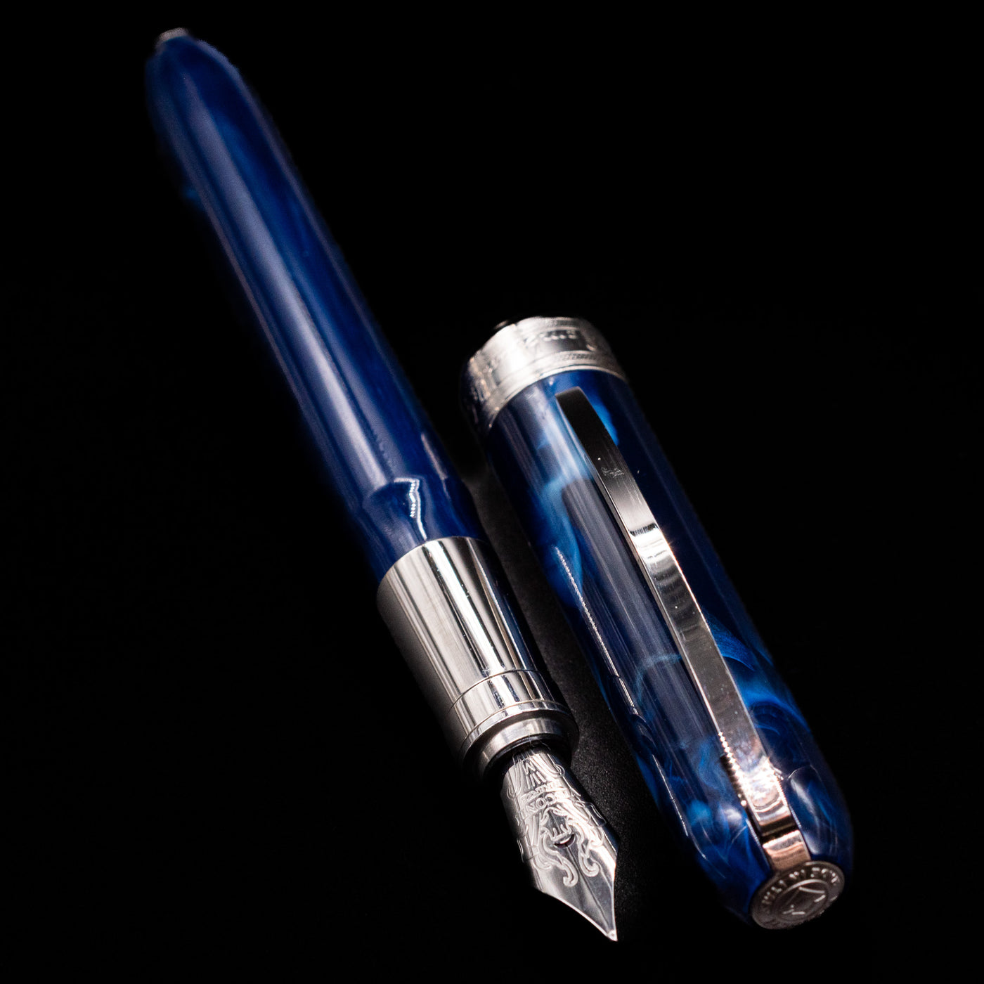 A full view of the Visconti Rembrandt Blue Fountain Pen - Preowned uncapped, with its cap laying next to the pen. 