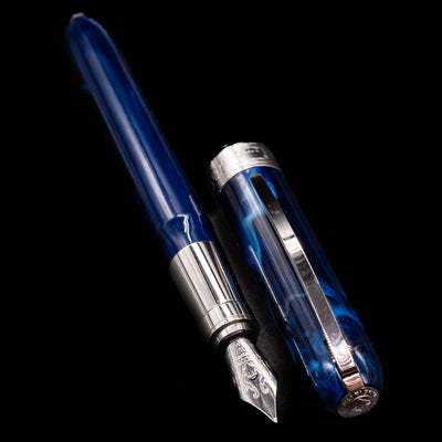 A full view of the Visconti Rembrandt Blue Fountain Pen - Preowned uncapped, with its cap laying next to the pen. 