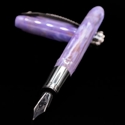 Visconti Rembrandt S Fountain Pen - Lavender laying across its own cap, crossed, with a focus on the nib.