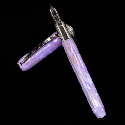 Visconti Rembrandt S Fountain Pen - Lavender laying on top of its cap in a crossed position showing full view of the entire uncapped pen.