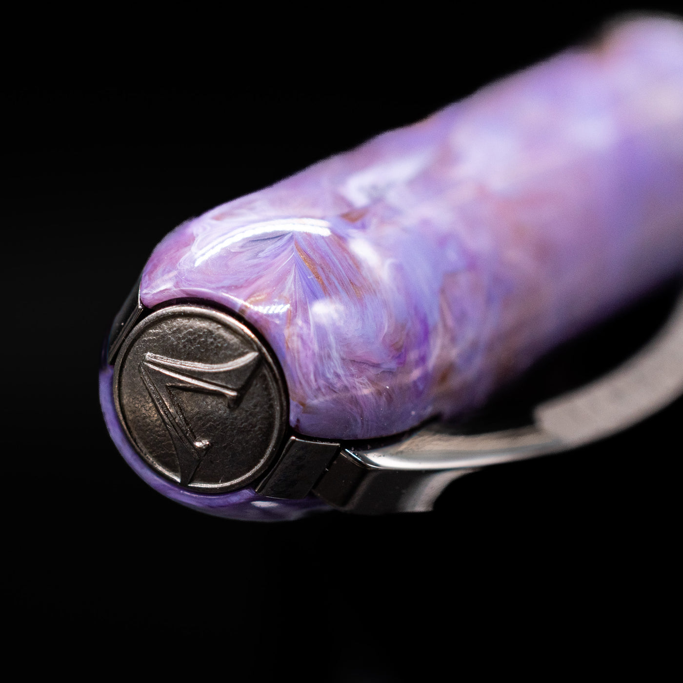 Zoomed-in view of the top of the cap with the Visconti finial on the Visconti Rembrandt S Fountain Pen - Lavender.
