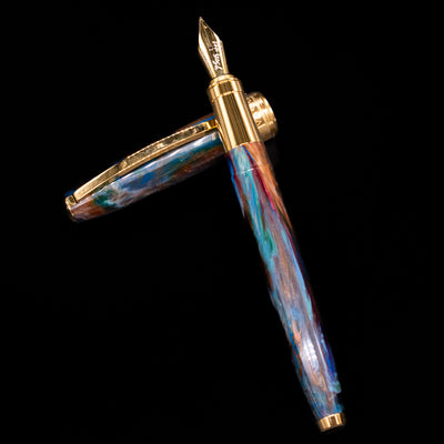 Visconti Van Gogh Fountain Pen - Oiran laying on top of its cap in a crossed position showing full view of the entire uncapped pen.