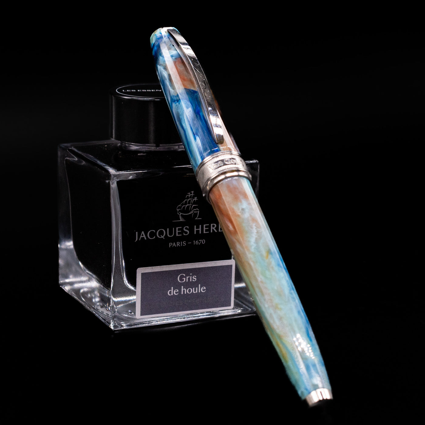 Visconti Van Gogh Fountain Pen - Self Portrait capped, leaning against an ink bottle. 