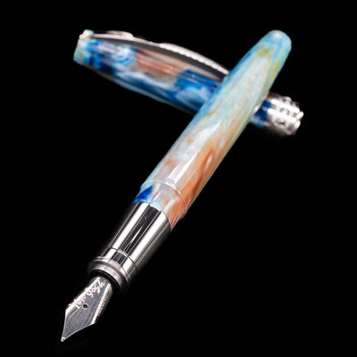 Visconti Van Gogh Fountain Pen - Self Portrait laying across its own cap, crossed, with a focus on the nib.