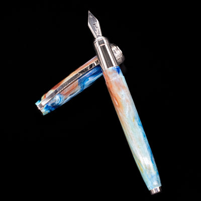 Visconti Van Gogh Fountain Pen - Self Portrait laying on top of its cap in a crossed position showing full view of the entire uncapped pen.