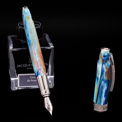 Visconti Van Gogh Fountain Pen - Self Portrait leaning on an ink bottle uncapped showcasing the detailing on the nib.