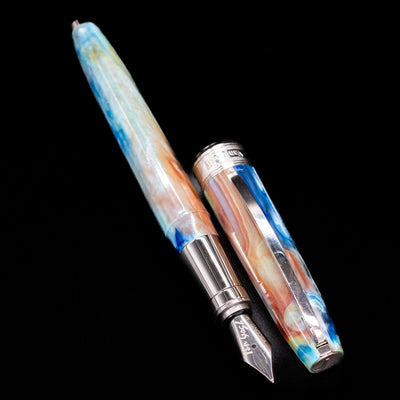 A full view of the Visconti Van Gogh Fountain Pen - Self Portrait uncapped, with its cap laying next to the pen. 