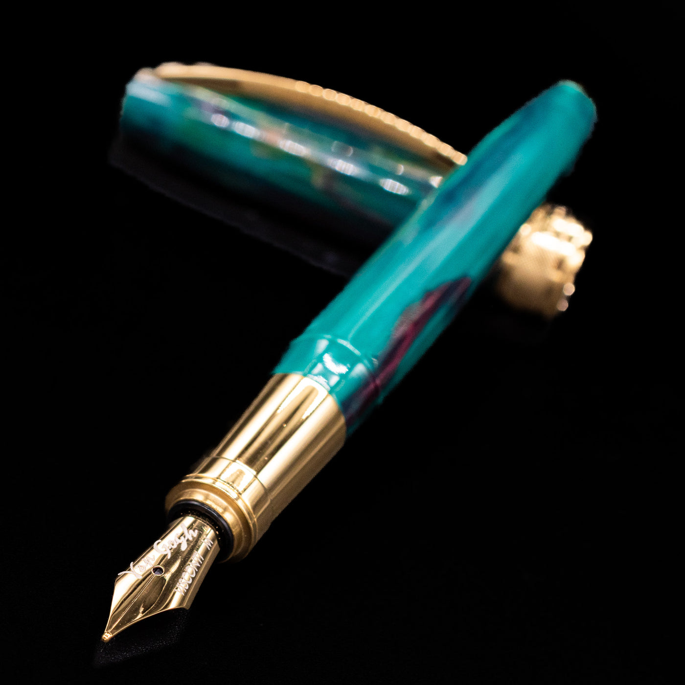 Visconti Van Gogh Fountain Pen - The Novel Reader laying across its own cap, crossed, with a focus on the nib.