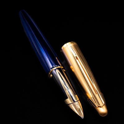 A full view of the Waterman Edson Sapphire Fountain Pen - Preowned uncapped, with its cap laying next to the pen. 
