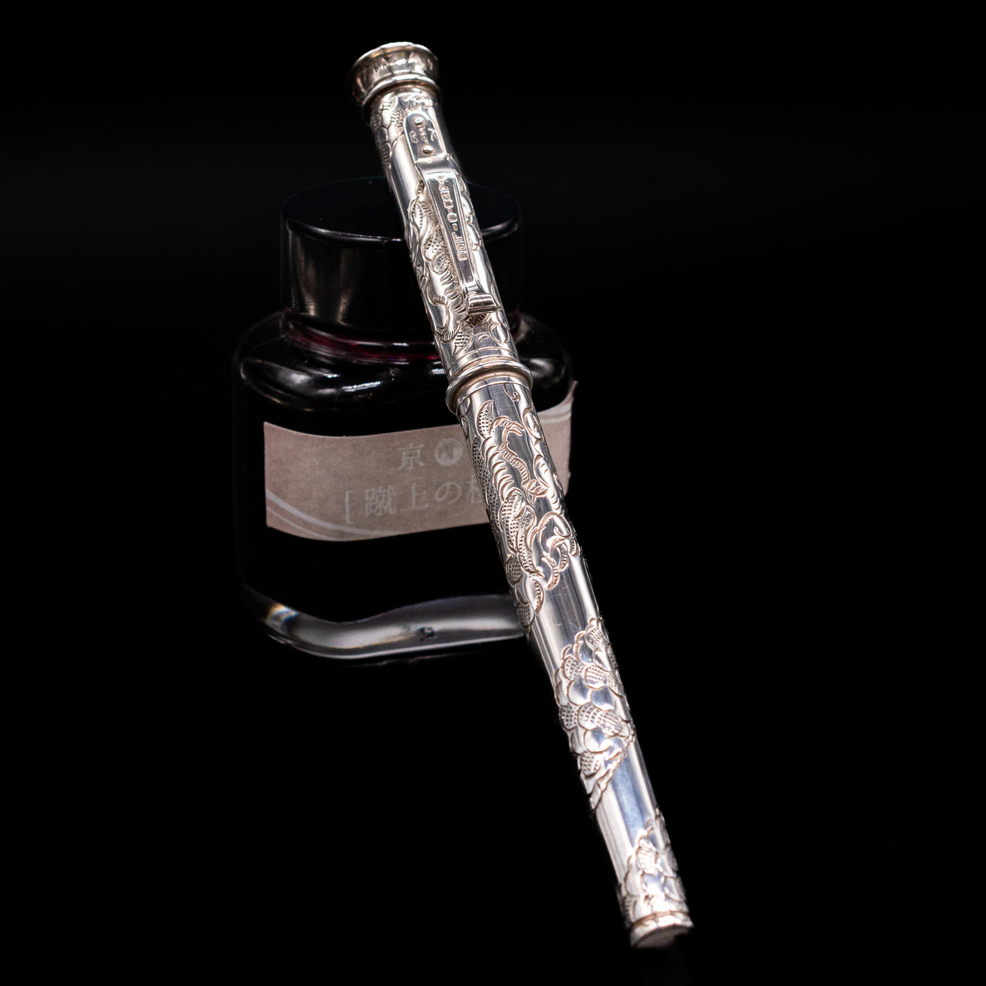 Yard O Led Imperial Dragon Fountain Pen - Preowned capped, leaning against an ink bottle. 