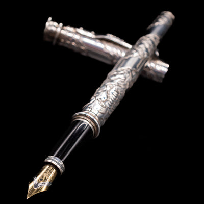 Yard O Led Imperial Dragon Fountain Pen - Preowned laying across its own cap, crossed, with a focus on the nib.