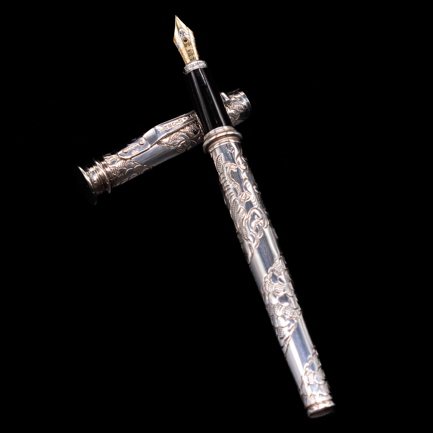 Yard O Led Imperial Dragon Fountain Pen - Preowned laying on top of its cap in a crossed position showing full view of the entire uncapped pen.