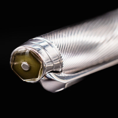 Closeup of Caran d'Ache Leman Terre d'Ombre Fountain Pen cap finial with olive enamel and hexagon inset