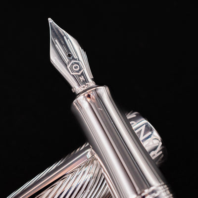 Detailed shot of the Caran d'Ache Leman Terre d'Ombre Fountain Pen 18k medium nib engraved with hexagon logo