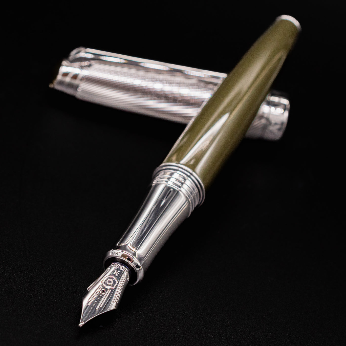 Closeup of Caran d'Ache Leman Terre d'Ombre Fountain Pen showing silver nib and green lacquer barrel