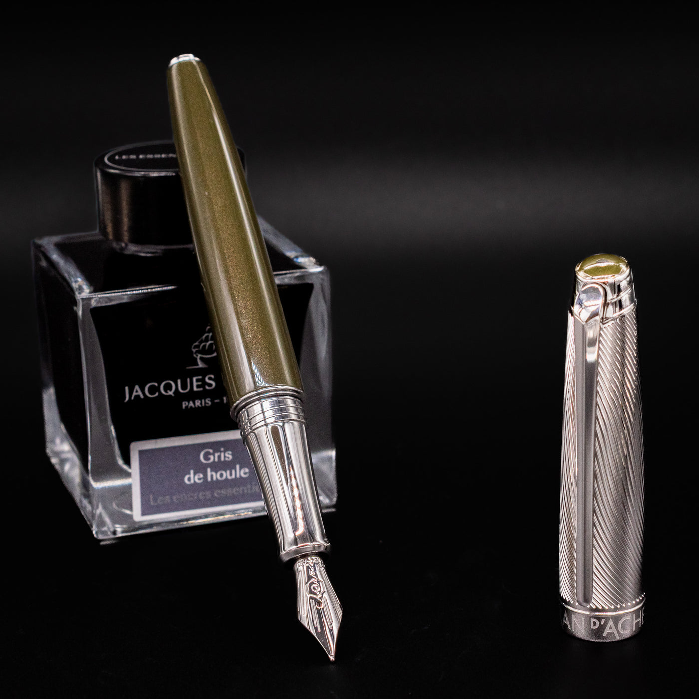 Caran d'Ache Leman Terre d'Ombre Fountain Pen with silver cap resting beside Jacques Herbin ink bottle