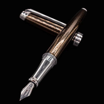 Caran d’Ache Léman V2 Caviar pen, uncapped with nib angled at the viewer
